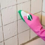 photo of scrub brush cleaning the bathroom tiles