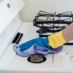 photo of cloth cleaning a  gas stove